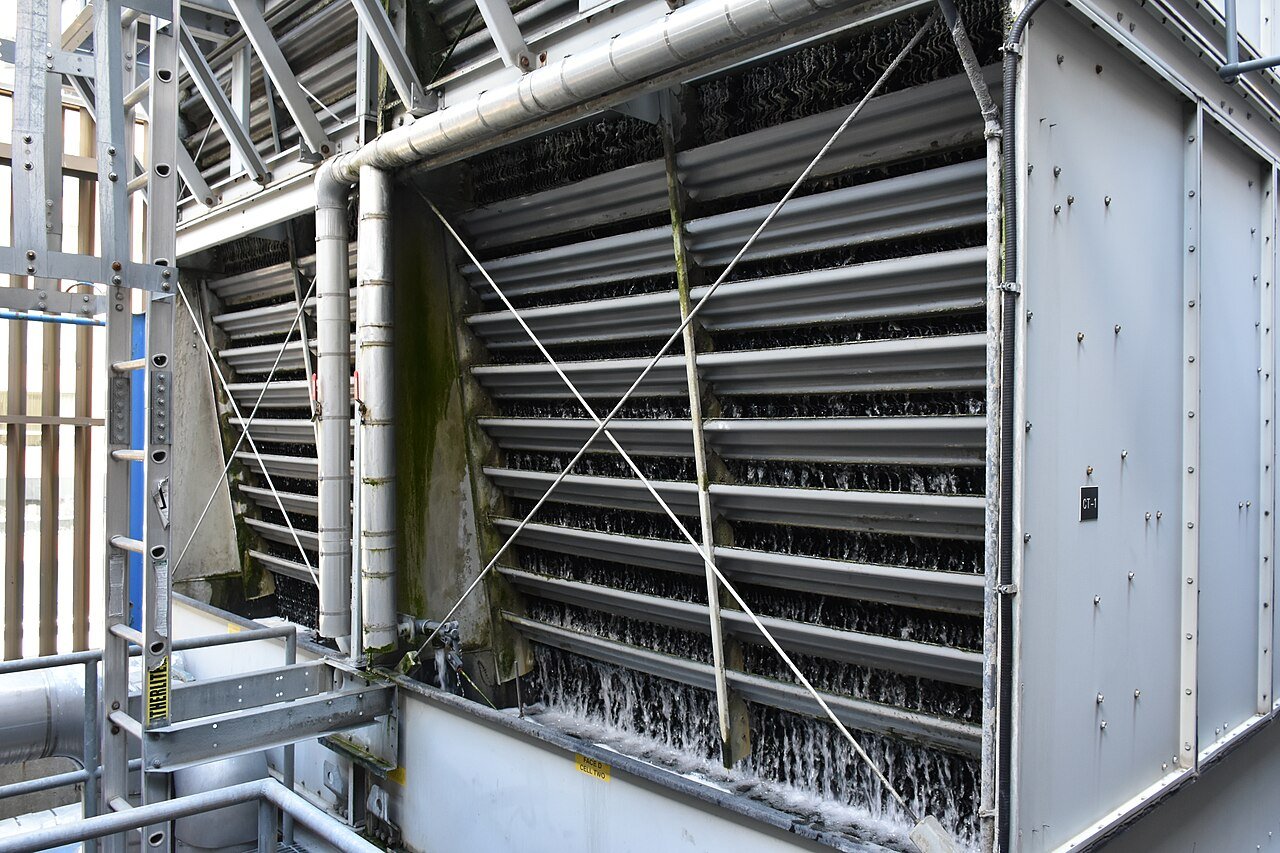 Algae and scale fouling the fill and louvers of a crossflow cooling tower cell